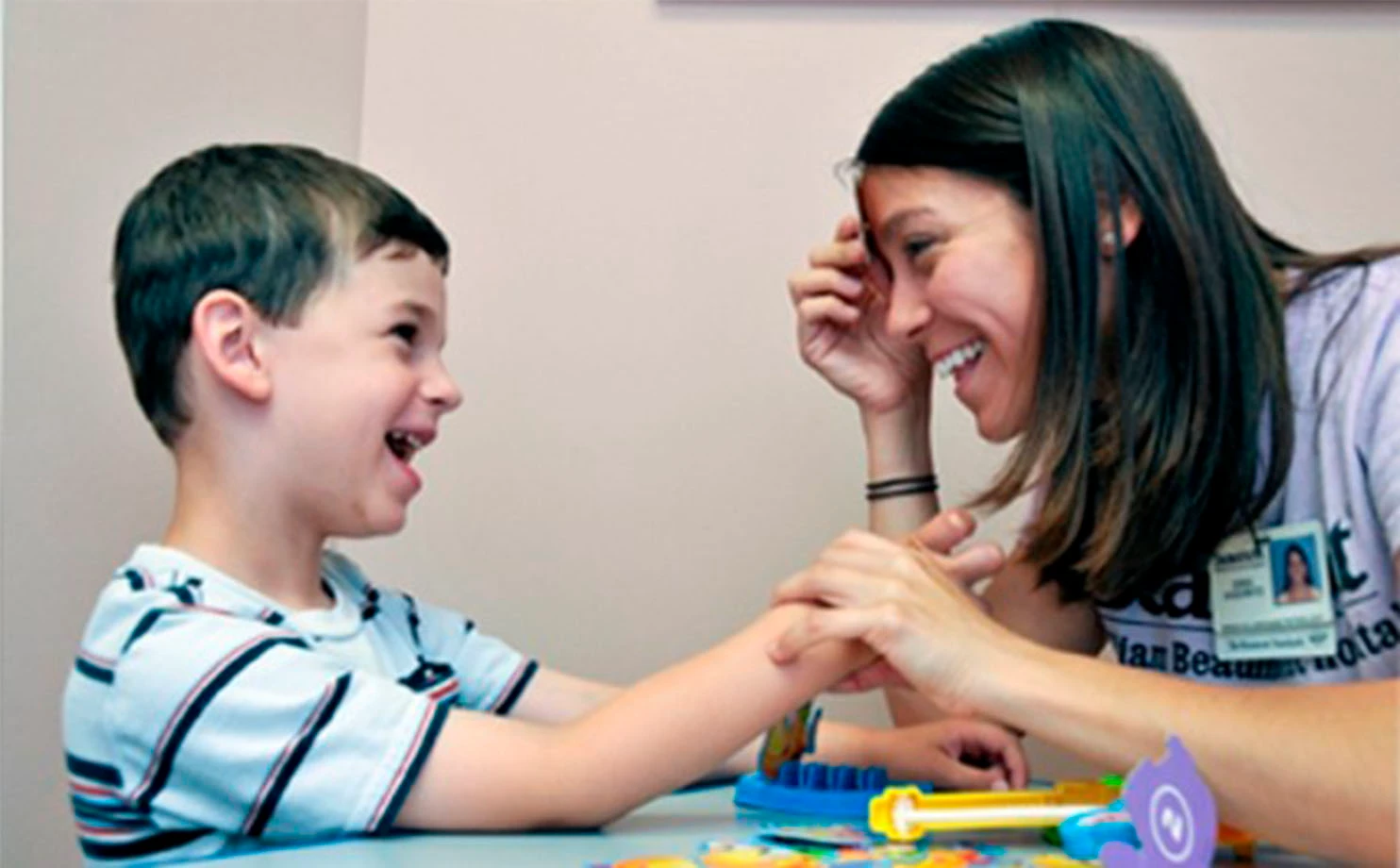 Smiling therapist with child autism diagnosis Calgary
