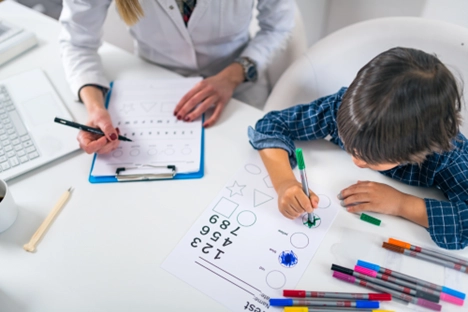 Child undergoing complex assessment with psychologist