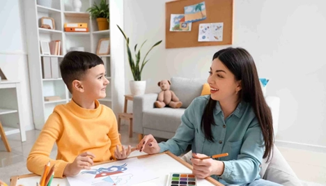 Therapist engaging child in autism psychoeducation session
